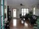 Cozy living room with dark leather sofas, hardwood floors, ceiling fan, and natural light at 11326 Brightridge Dr, Seffner, FL 33584