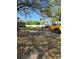 Side yard with trucks, trailers, storage container, and large trees at 11326 Brightridge Dr, Seffner, FL 33584