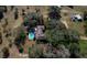 Aerial view of a private property with a blue pool and outbuildings nestled among mature trees at 11327 Carter Grove Ln, Thonotosassa, FL 33592