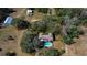 Aerial view of home featuring a pool and surrounding wooded area at 11327 Carter Grove Ln, Thonotosassa, FL 33592