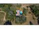 Aerial view of home featuring a pool, surrounded by trees and grass at 11327 Carter Grove Ln, Thonotosassa, FL 33592
