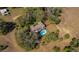 Aerial view of home surrounded by trees with an in-ground pool at 11327 Carter Grove Ln, Thonotosassa, FL 33592