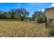Backyard pool surrounded by mature trees and a lawn, ideal for outdoor enjoyment at 11327 Carter Grove Ln, Thonotosassa, FL 33592