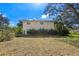 Backyard featuring the property, mature trees, and lush landscaping, offering privacy at 11327 Carter Grove Ln, Thonotosassa, FL 33592