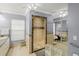 Bathroom featuring a walk-in shower with mosaic tile and glass surround and large mirror at 11327 Carter Grove Ln, Thonotosassa, FL 33592
