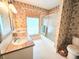 The bathroom features a double vanity, walk-in shower, and a window for natural light at 11327 Carter Grove Ln, Thonotosassa, FL 33592