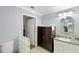 Bathroom featuring gray walls, white crown molding, a glass block partition, and a vanity with gray countertop at 11327 Carter Grove Ln, Thonotosassa, FL 33592