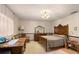 Carpeted bedroom features dark wood furniture, desk area, and neutral wall coloring at 11327 Carter Grove Ln, Thonotosassa, FL 33592