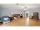 Bedroom featuring wood-look flooring, light gray walls, a ceiling fan, and a closet at 11327 Carter Grove Ln, Thonotosassa, FL 33592