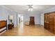 Bedroom featuring wood-look flooring, light gray walls, two closets, and access to kitchen and bathroom at 11327 Carter Grove Ln, Thonotosassa, FL 33592