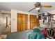 This bedroom shows a cluttered space with ceiling fan at 11327 Carter Grove Ln, Thonotosassa, FL 33592