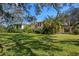 Two-story home framed by mature trees and a large lawn, exuding curb appeal at 11327 Carter Grove Ln, Thonotosassa, FL 33592
