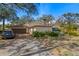 Home featuring an attached garage, with lush landscaping, enhancing the property's charm at 11327 Carter Grove Ln, Thonotosassa, FL 33592
