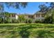 Charming two-story home with lush green lawn and mature landscaping at 11327 Carter Grove Ln, Thonotosassa, FL 33592