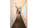 This hallway with brick floors leads to a staircase and bedroom at 11327 Carter Grove Ln, Thonotosassa, FL 33592
