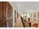 Long hallway with shutters and railing, overlooking a living area at 11327 Carter Grove Ln, Thonotosassa, FL 33592