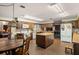 Spacious kitchen featuring a brick floor, a center island and white appliances at 11327 Carter Grove Ln, Thonotosassa, FL 33592