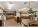 Spacious kitchen features wood cabinets, island, brick floors, and modern appliances at 11327 Carter Grove Ln, Thonotosassa, FL 33592