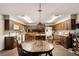 Wide kitchen offers wood cabinets, island, brick floors, eat in space, and appliances at 11327 Carter Grove Ln, Thonotosassa, FL 33592