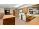 Traditional kitchen with an island, brick floors, wood cabinets, and white appliances at 11327 Carter Grove Ln, Thonotosassa, FL 33592