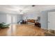 Living room featuring laminate floors, light walls, access to backyard, and recessed lighting at 11327 Carter Grove Ln, Thonotosassa, FL 33592