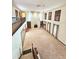 A spacious living room with a stone fireplace, built-in shelves, and lots of natural light from the large windows at 11327 Carter Grove Ln, Thonotosassa, FL 33592