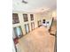 Spacious living room boasting natural light from large windows with two-story height and staircase access at 11327 Carter Grove Ln, Thonotosassa, FL 33592