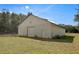 Exterior of white metal outbuilding with roll-up door and walk-in door at 11327 Carter Grove Ln, Thonotosassa, FL 33592