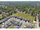 This aerial view displays a community with well-maintained landscaping and desirable homes with pools at 1241 Florablu Dr, Seffner, FL 33584