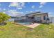 This backyard features a pool and patio area with a lush green lawn, ideal for outdoor enjoyment at 1241 Florablu Dr, Seffner, FL 33584