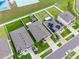 A bird's-eye view of homes with lush green lawns, backyard features, and solar panels at 12635 Tannencrest Dr, Riverview, FL 33579