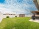 Large, grassy backyard featuring a storage shed and patio with a pergola at 12635 Tannencrest Dr, Riverview, FL 33579