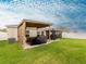 Beautiful backyard with a covered patio, grill, and well-maintained green lawn at 12635 Tannencrest Dr, Riverview, FL 33579