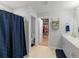 Bright bathroom featuring a double sink vanity, walk-in closet, and a shower with a blue curtain at 12635 Tannencrest Dr, Riverview, FL 33579
