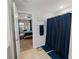 Bathroom view into bedroom with a shower featuring a blue curtain at 12635 Tannencrest Dr, Riverview, FL 33579
