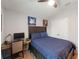 Bedroom featuring a ceiling fan, bed, and desk; a nice, relaxing space at 12635 Tannencrest Dr, Riverview, FL 33579