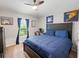 Bedroom with ceiling fan, bed, window, and a desk; a place to relax or study at 12635 Tannencrest Dr, Riverview, FL 33579