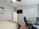 Bedroom featuring a ceiling fan, bed, and desk; a nice, relaxing space at 12635 Tannencrest Dr, Riverview, FL 33579