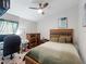 Bedroom with ceiling fan, wood furniture, and a comfortable bed at 12635 Tannencrest Dr, Riverview, FL 33579