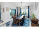 Bright dining room with a wood table set for six, blue accents, and sliding doors leading to the patio at 12635 Tannencrest Dr, Riverview, FL 33579
