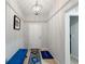 Bright entryway with hardwood floors, overhead lighting, and a blue bench at 12635 Tannencrest Dr, Riverview, FL 33579