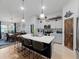 Modern kitchen featuring a large island with seating, stainless steel appliances, and open dining area at 12635 Tannencrest Dr, Riverview, FL 33579