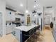 Modern kitchen with an island, seating for four, stainless steel appliances, white cabinets, and stylish backsplash at 12635 Tannencrest Dr, Riverview, FL 33579