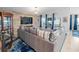 Inviting living room features a large sofa, rustic accent wall, and plenty of natural light at 12635 Tannencrest Dr, Riverview, FL 33579
