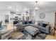 Open concept living room with a comfortable sofa, kitchen view, and bright lighting at 12635 Tannencrest Dr, Riverview, FL 33579