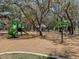 Community playground with mature trees and various playground equipment at 12635 Tannencrest Dr, Riverview, FL 33579