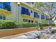 Charming townhome exterior featuring black iron balconies and lush hedge landscaping at 133 S Sherrill St # 133, Tampa, FL 33609