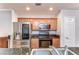 Efficient kitchen with granite countertops, stainless steel appliances and ample wood cabinetry at 133 S Sherrill St # 133, Tampa, FL 33609