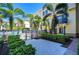 Community pool area offers relaxation and tropical vibes with palm trees surrounding residential buildings at 133 S Sherrill St # 133, Tampa, FL 33609