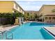 Community pool with lounge chairs and tropical landscaping in a courtyard setting at 133 S Sherrill St # 133, Tampa, FL 33609